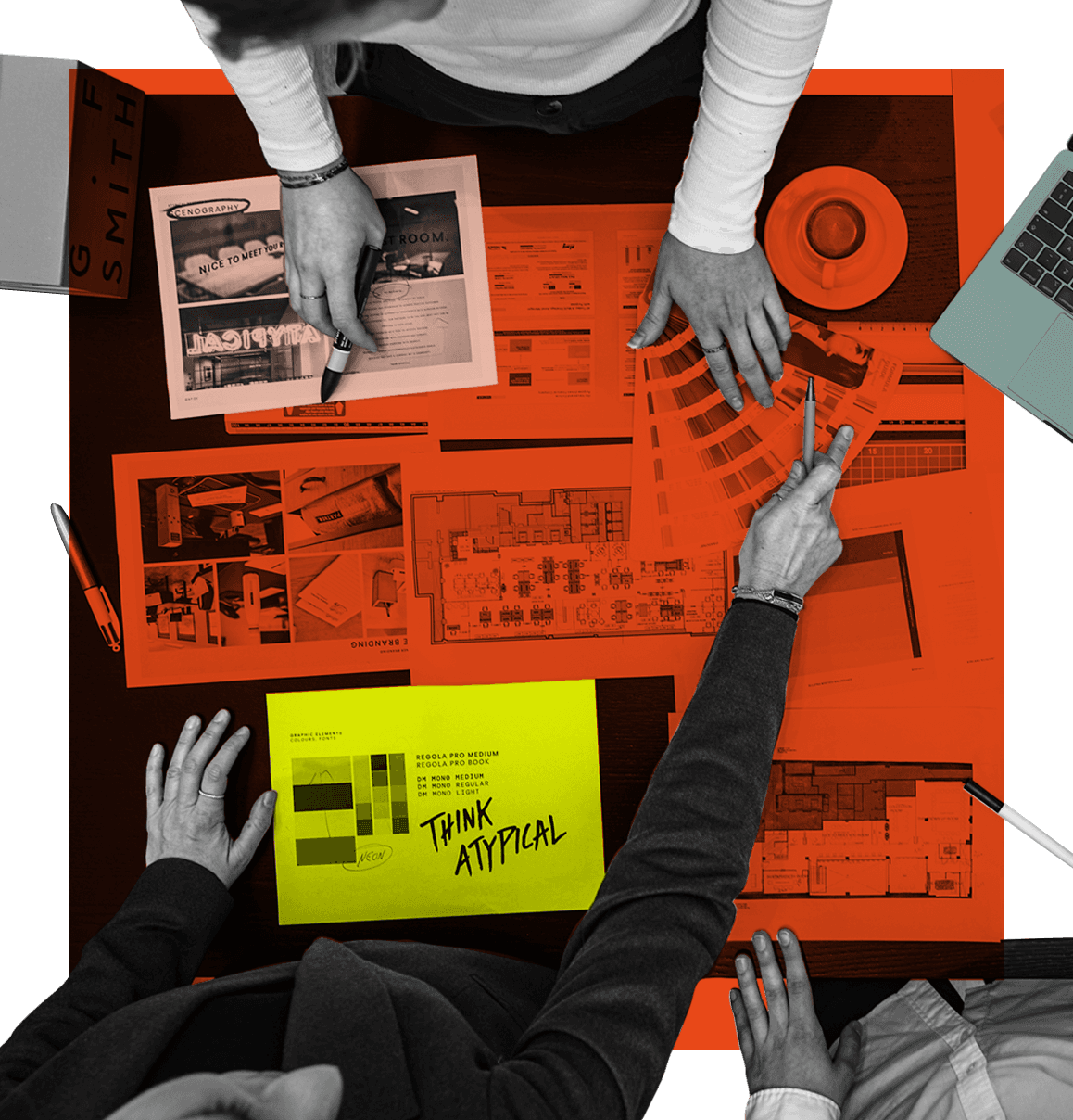 Birdseye view of employees discussing projects.